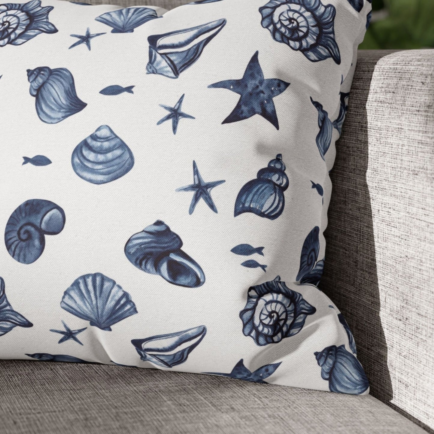 Close-up of seashell pillow cover on white swing — nature-inspired summer style
