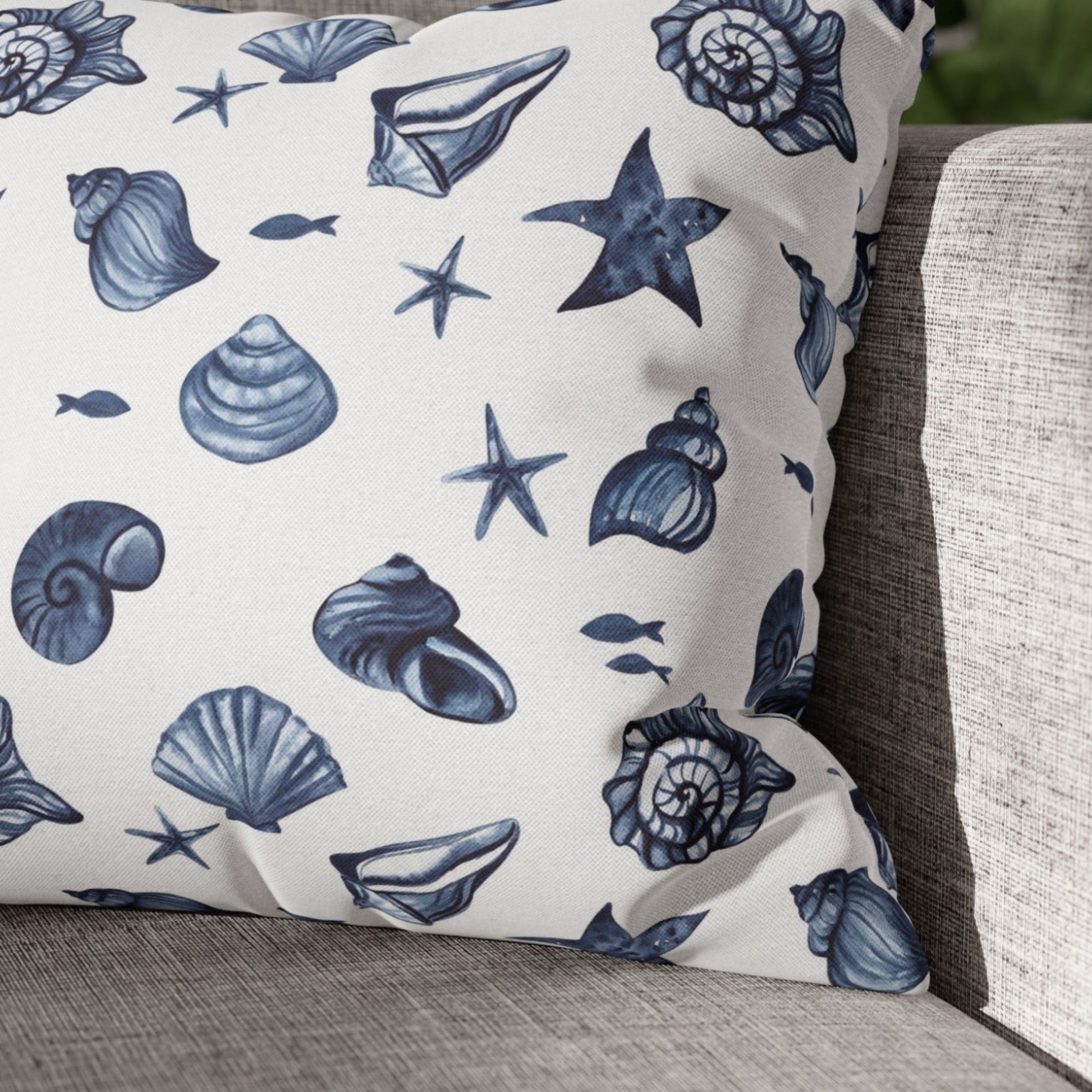 Close-up of seashell pillow cover on white swing — nature-inspired summer style