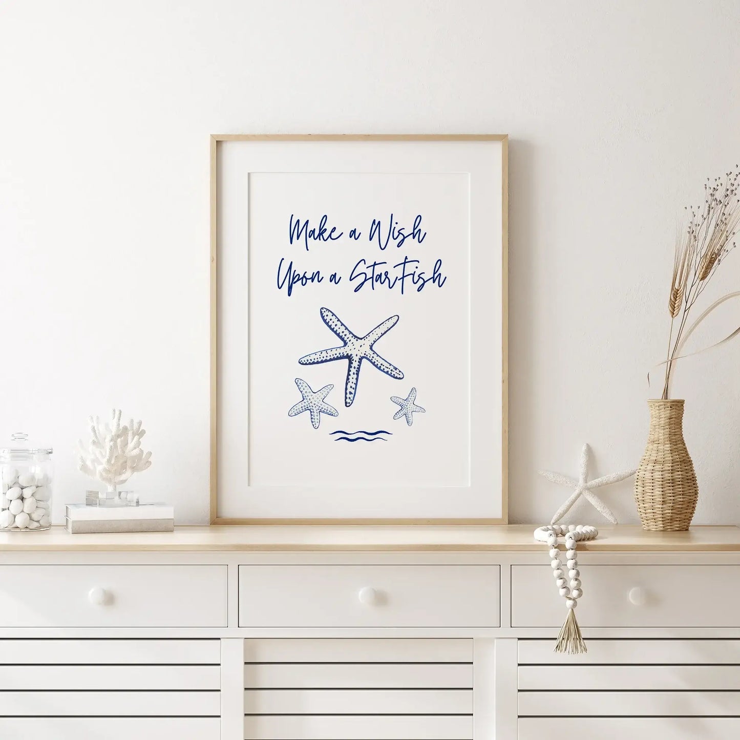 Coastal console table styled with starfish and coral decor, featuring a framed "Make a Wish Upon a Starfish" digital download wall art.