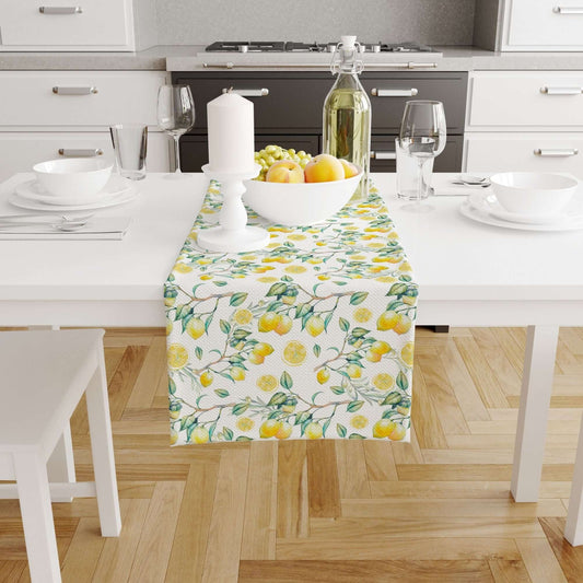 Summer Lemon TABLE RUNNER on a dining table decorated with fresh lemons and a candle.