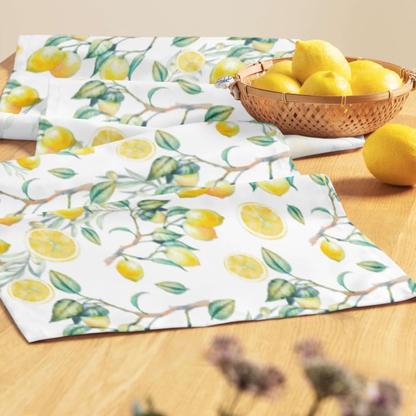 Summer Lemon TABLE RUNNER with hand-painted watercolor lemons on a wooden table, alongside a basket of fresh lemons.