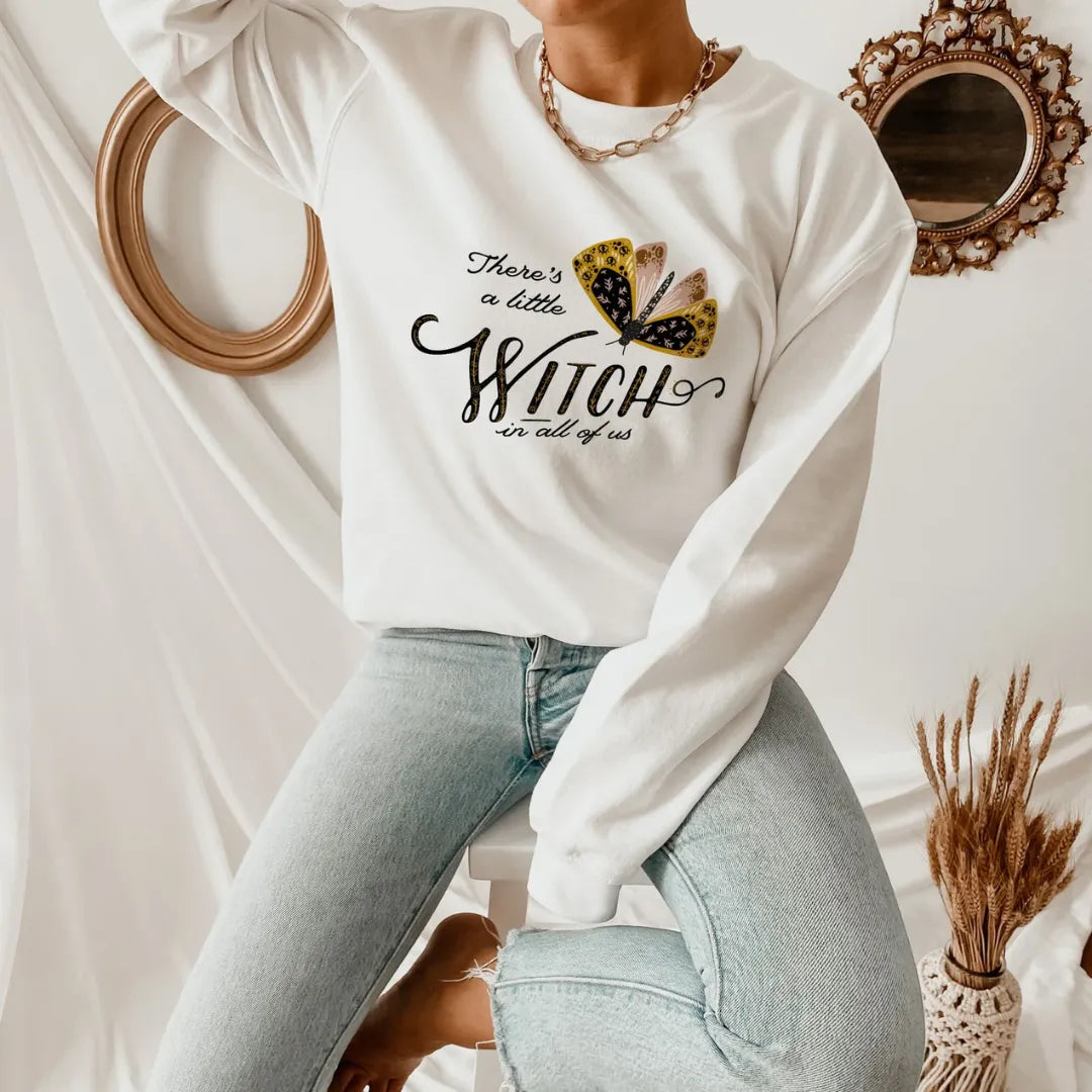 woman wearing Moth Witch SWEATSHIRTS from Blue Water Songs sitting on chair