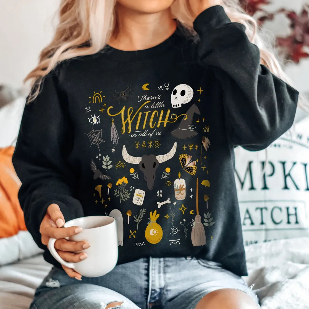 woman in There's a little witch SWEATSHIRTS from Blue Water Songs with coffee mug in her hand