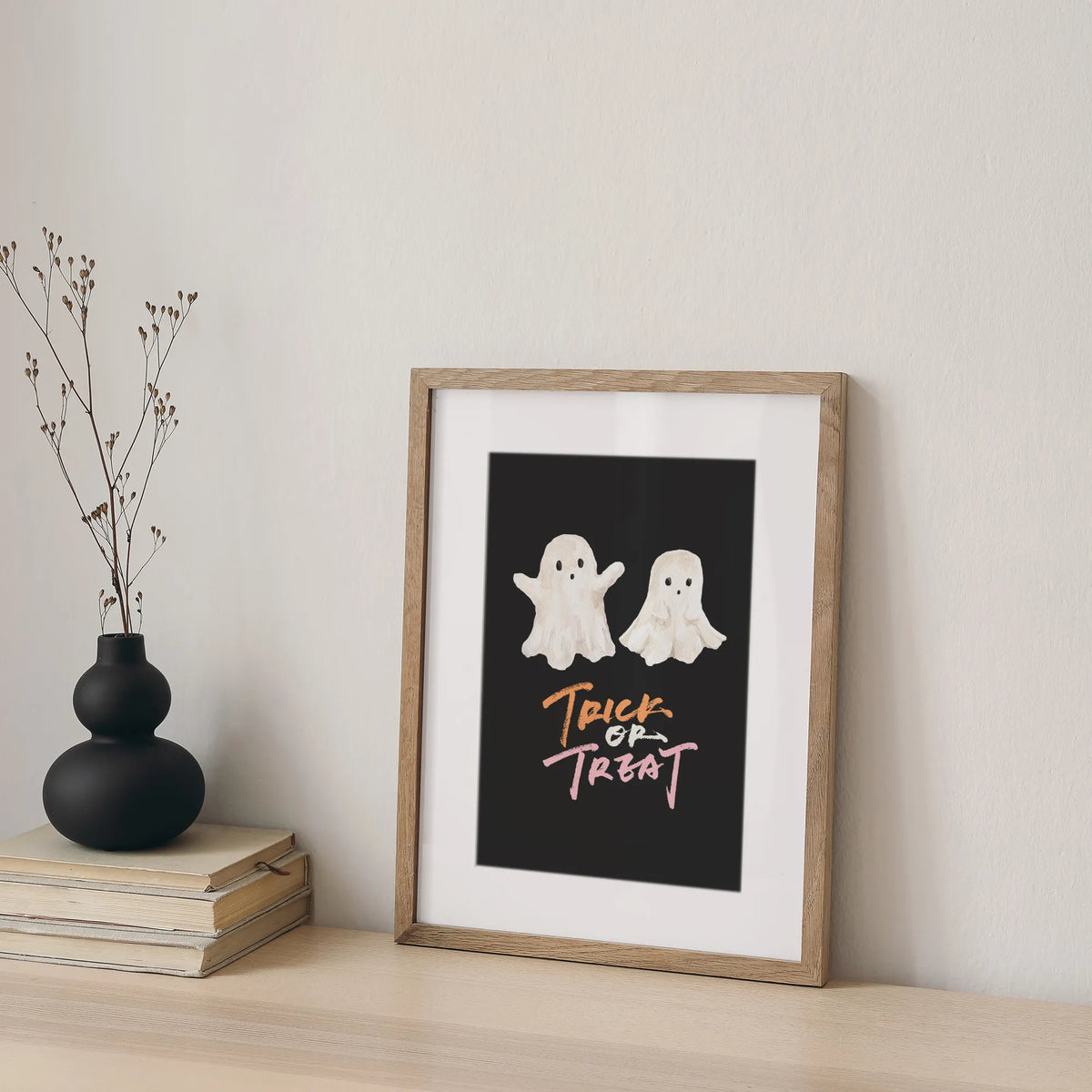Trick or Treat Ghost Printable wall art with two cute watercolor ghosts in wooden frame.
