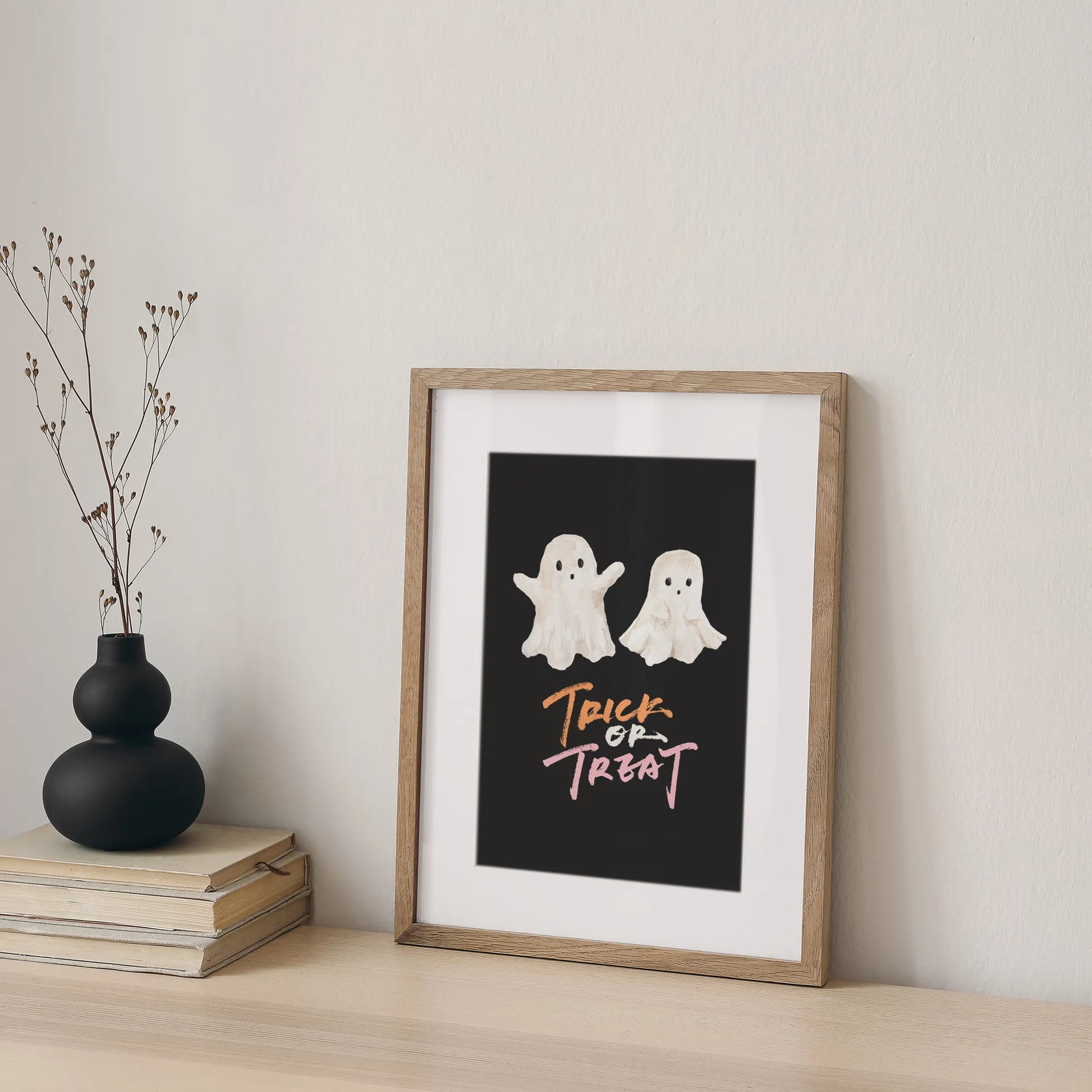 Watercolor Cute Ghost Halloween art print from Blue Water Songs placing on shelf next to pile of books