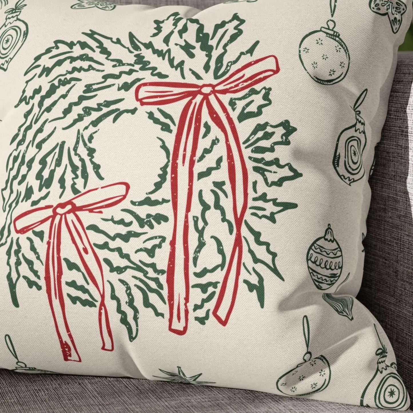 Retro Christmas Pillow featuring hand-drawn green wreaths and red bows on soft ivory fabric for vintage holiday decor.