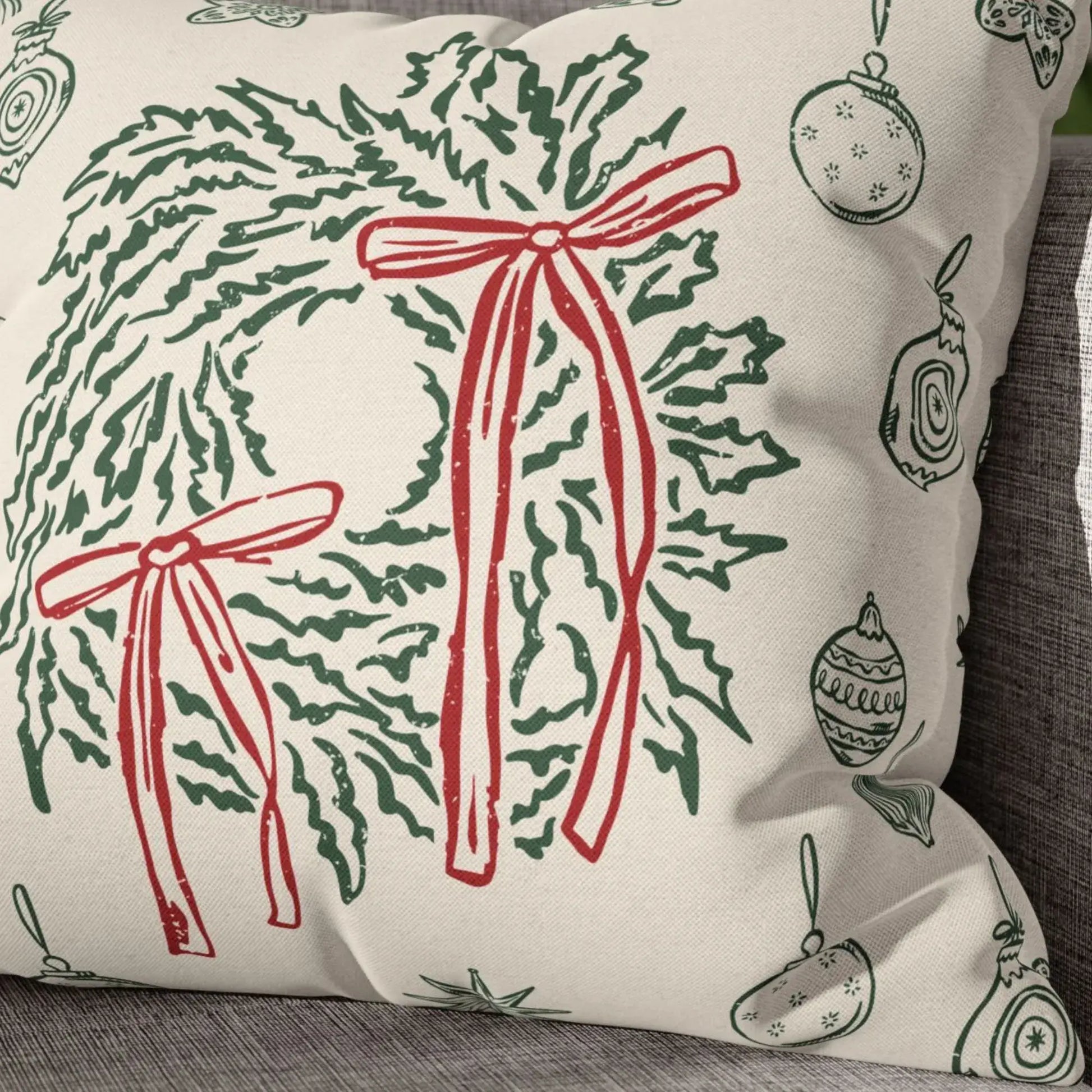 Retro Christmas Pillow featuring hand-drawn green wreaths and red bows on soft ivory fabric for vintage holiday decor.