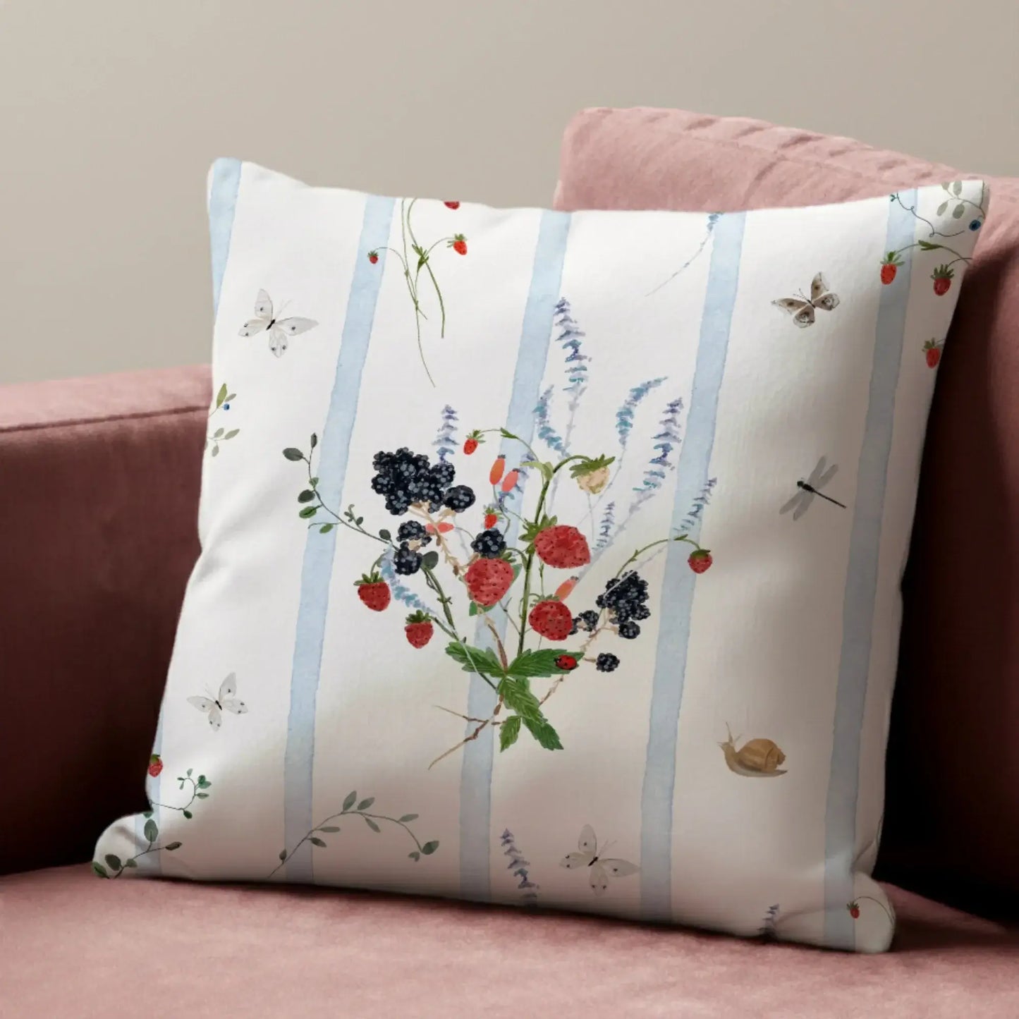 Watercolor Berry Botanical Pillow featuring strawberries, blackberries, and soft blue stripes on a cozy couch.
