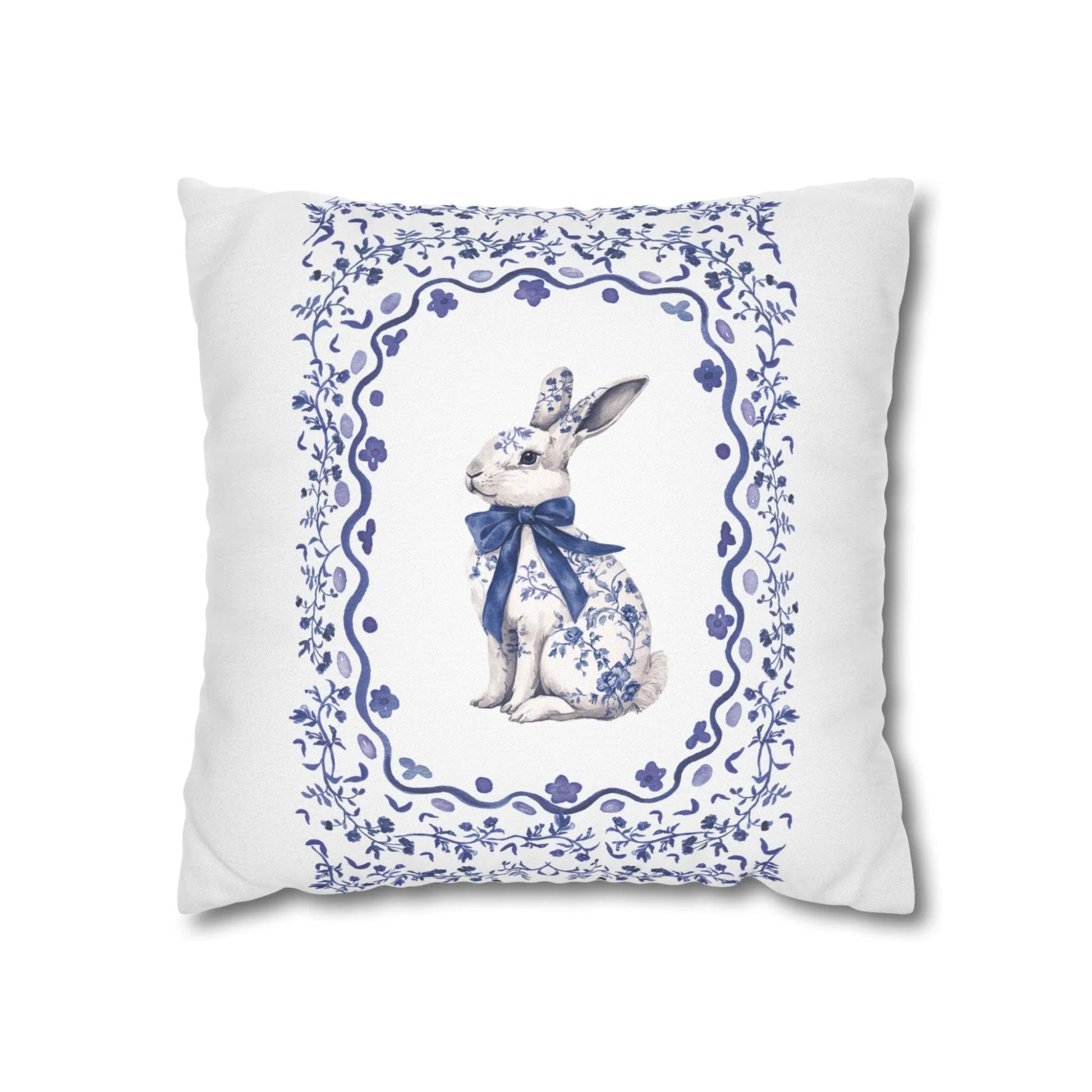 Square white pillowcase with a blue watercolor Chinoiserie rabbit wearing a bow, enclosed in a decorative floral frame.