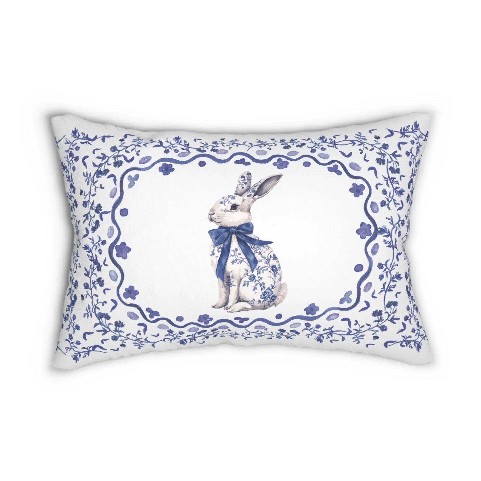 Lumbar pillow featuring a blue watercolor Chinoiserie rabbit with a bow, framed by an elegant floral design.
