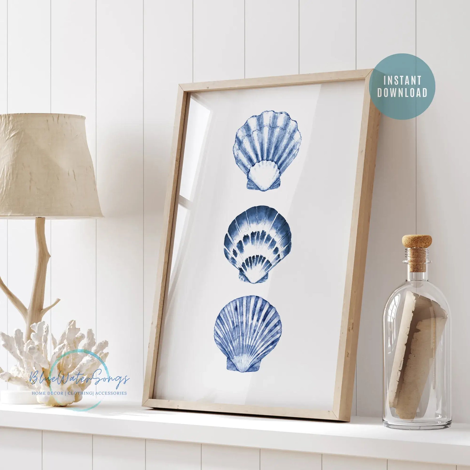 Framed watercolor blue seashell art print displayed on white shelf with coastal decor, instant digital download for beach house or summer home styling.
