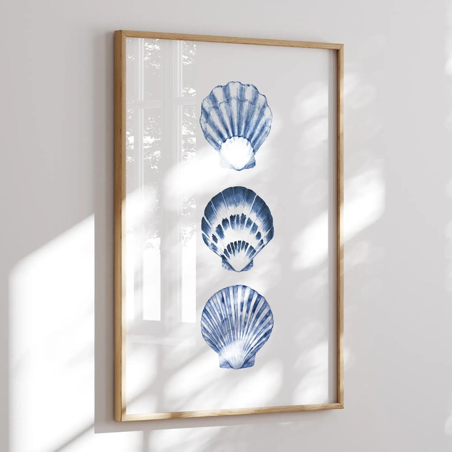 Coastal watercolor blue seashells art print framed in wood, minimalist summer wall decor with sunlight reflections, digital download for beach house style.