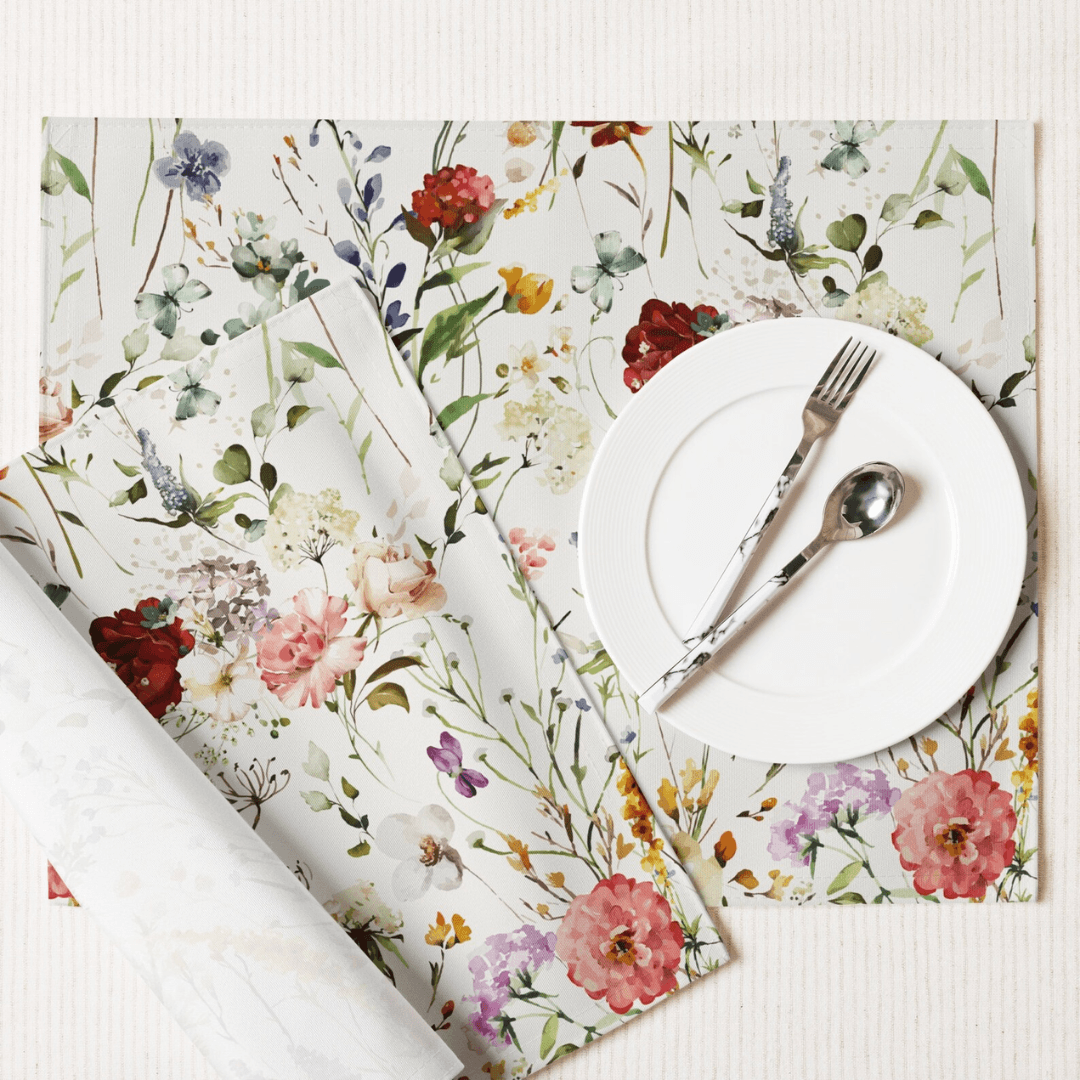 Watercolor Boho Wildflowers Placemat Set featuring vibrant floral designs with a white plate and silver utensils.