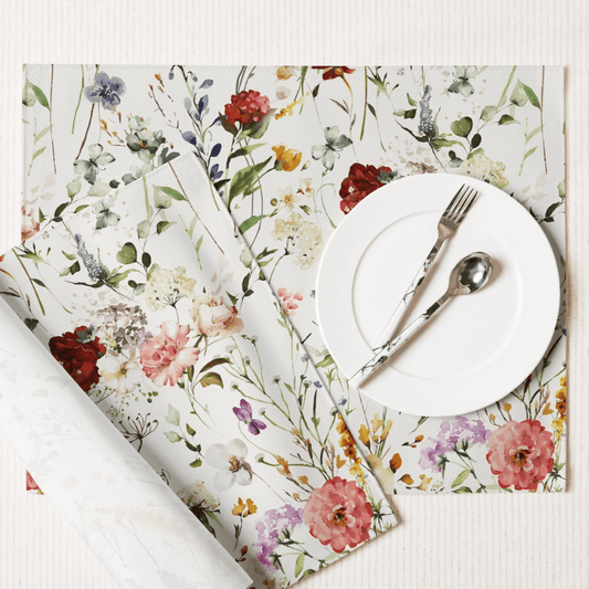 Watercolor Boho Wildflowers Placemat Set featuring vibrant floral designs with a white plate and silver utensils.