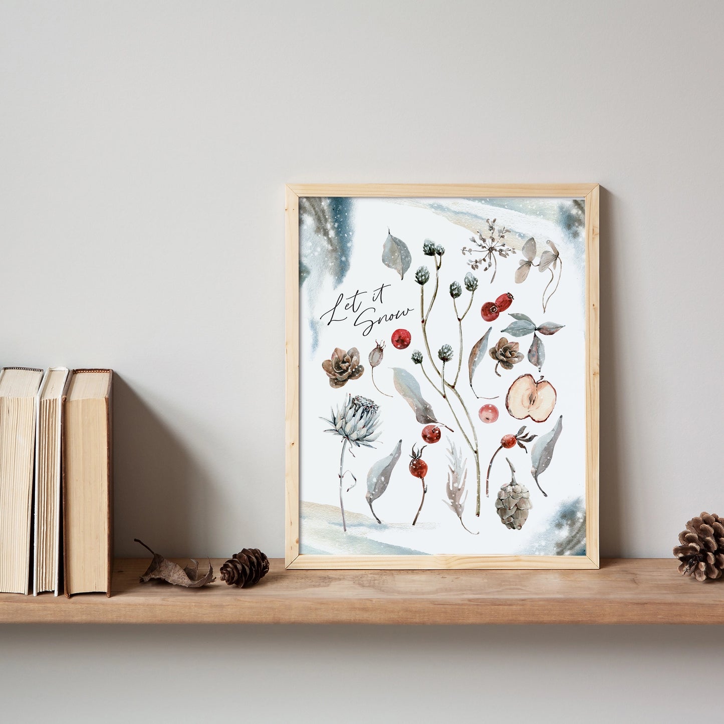 Botanical Christmas print art featuring watercolor plants and flowers in a wood frame on a shelf