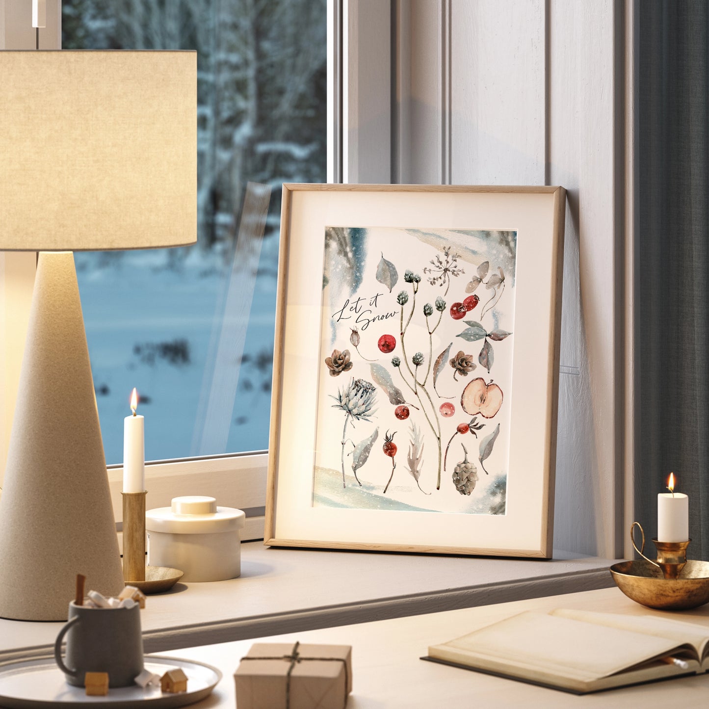 Botanical Christmas print art displayed in a cozy window setting with a lamp and candles.