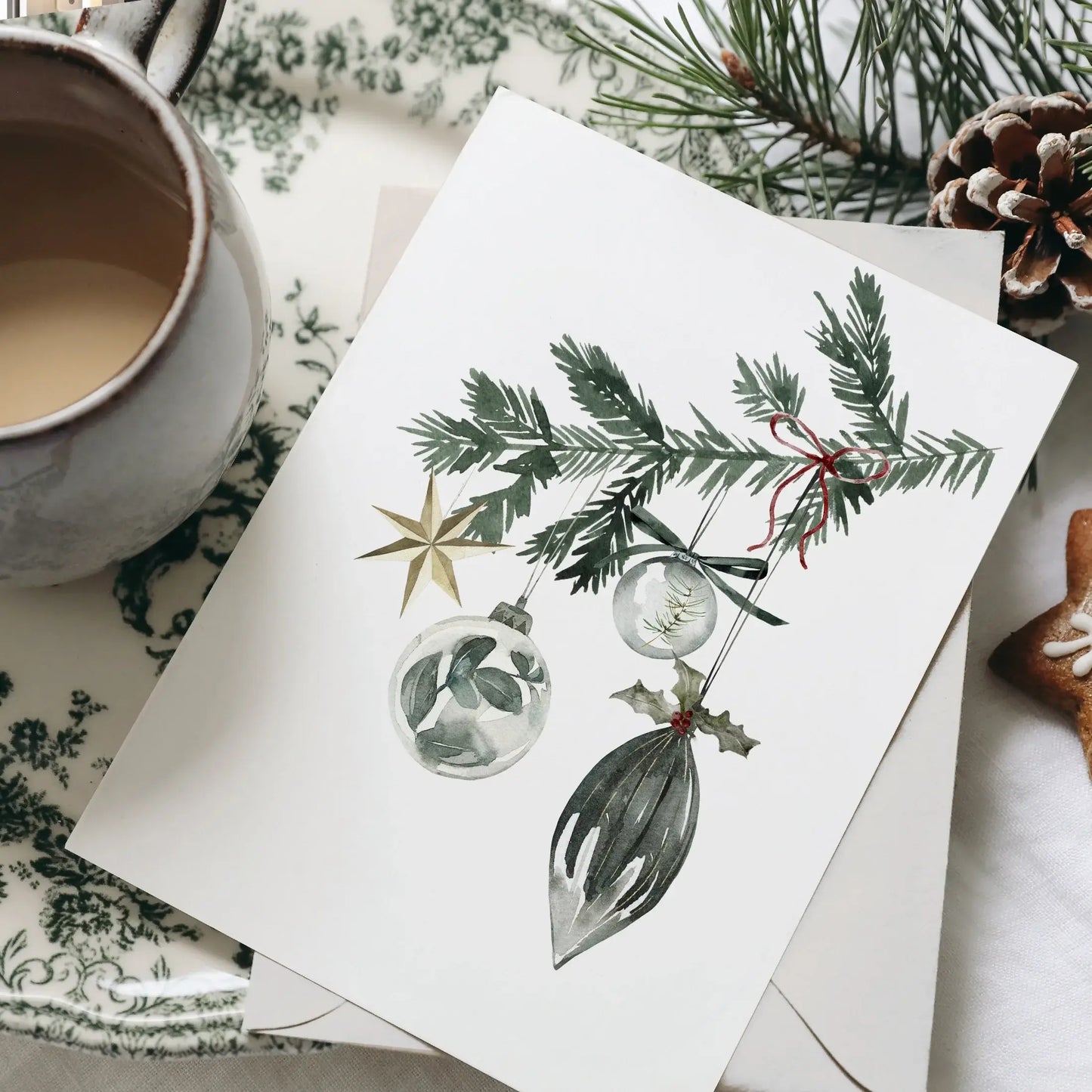 Christmas Ornaments Print Art featuring watercolor ornaments and evergreen branch on a rustic table setting.
