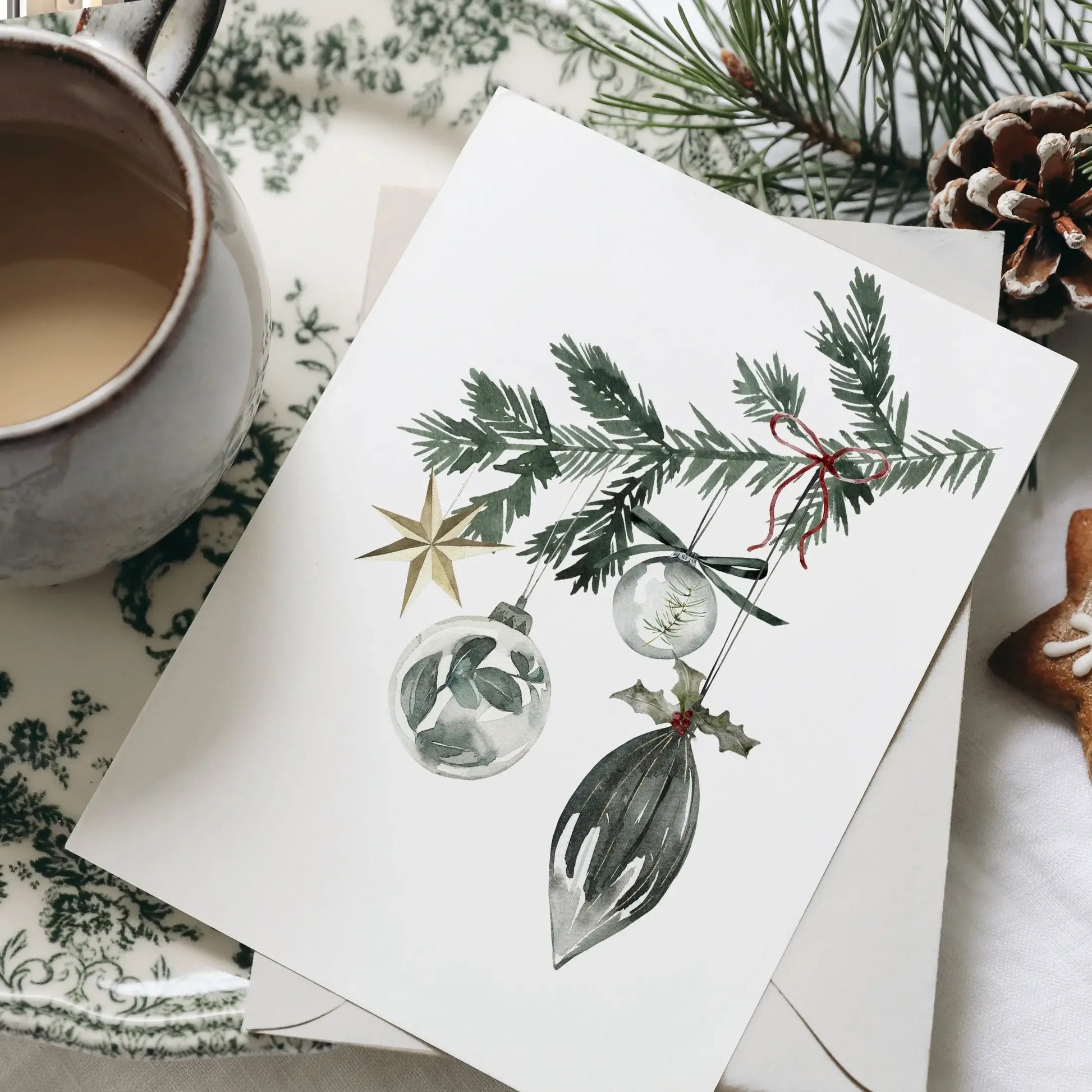 Christmas Ornaments Print Art featuring watercolor ornaments and evergreen branch on a rustic table setting.