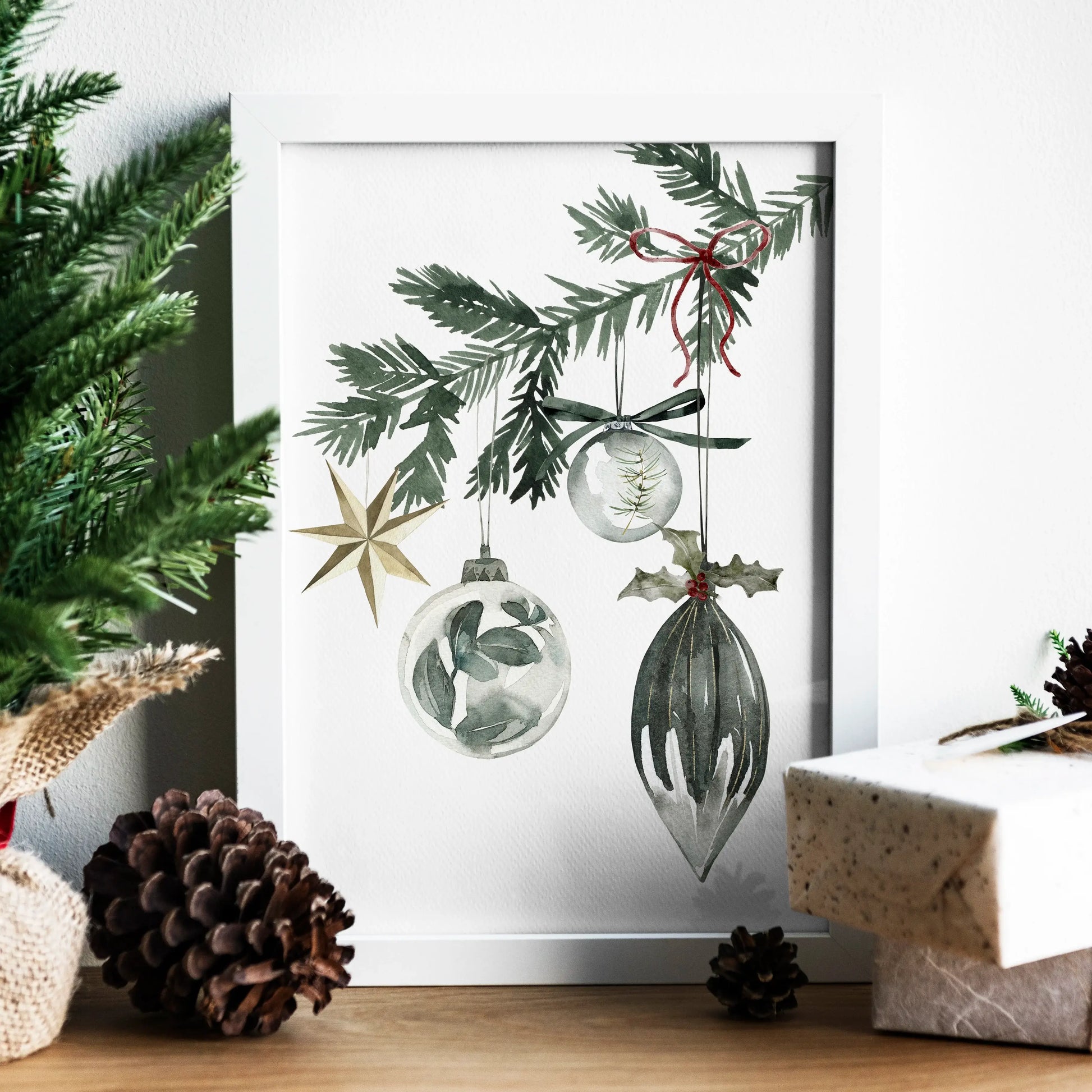 Christmas Ornaments Print Art showcasing watercolor ornaments hanging from a pine branch, surrounded by holiday decor.