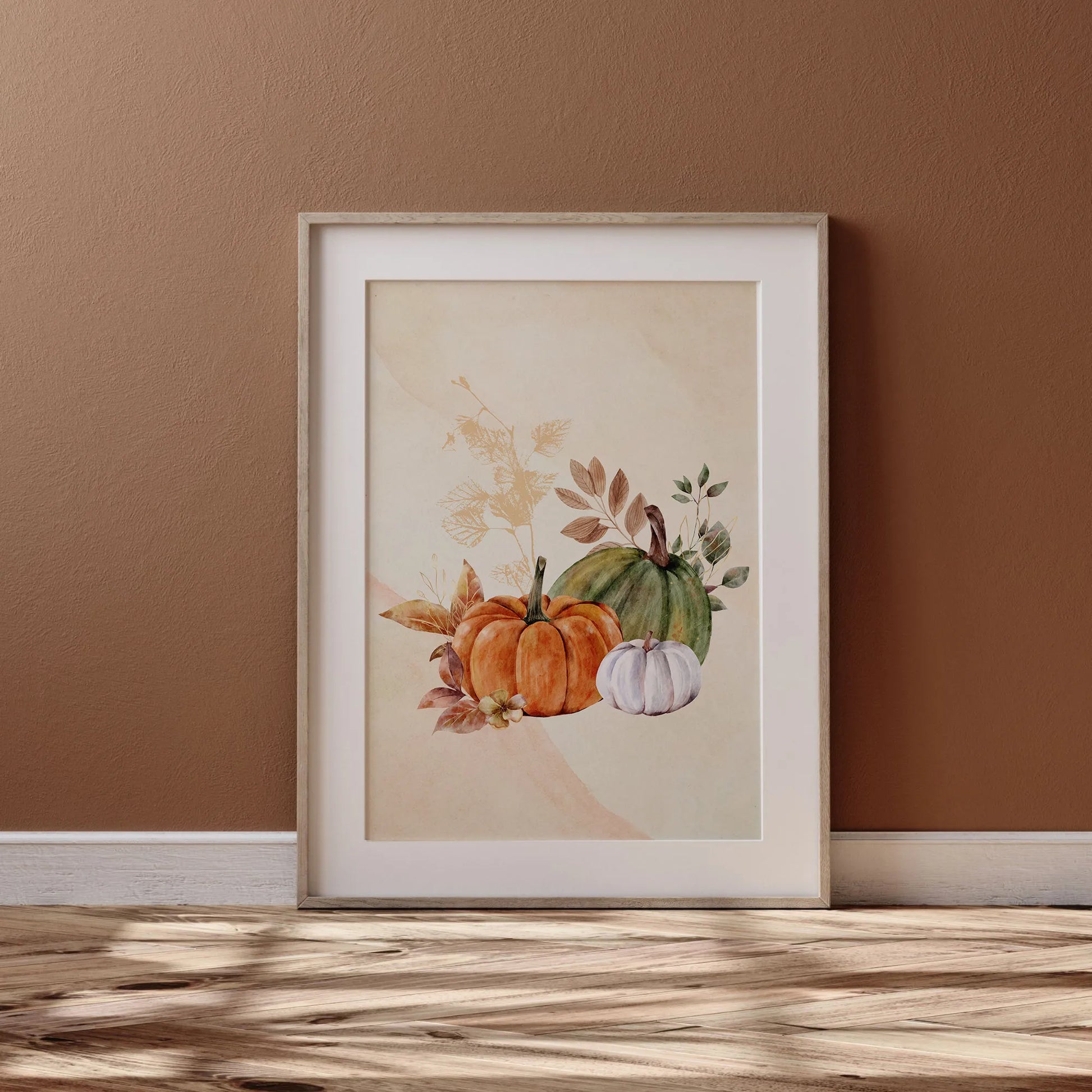 Watercolor Fall Pumpkin poster from Blue Water Songs in wood frame leaning against brown wall