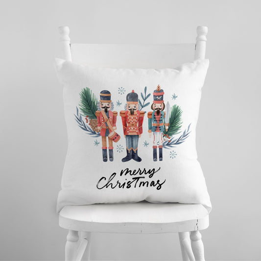 Watercolor nutcracker Christmas pillow with three toy soldiers and holiday greenery – festive seasonal decor