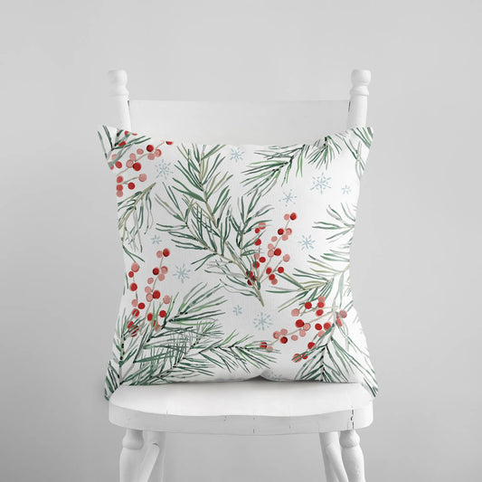 White pillow with watercolor pine branches, red berries, and snowflakes holiday cushion