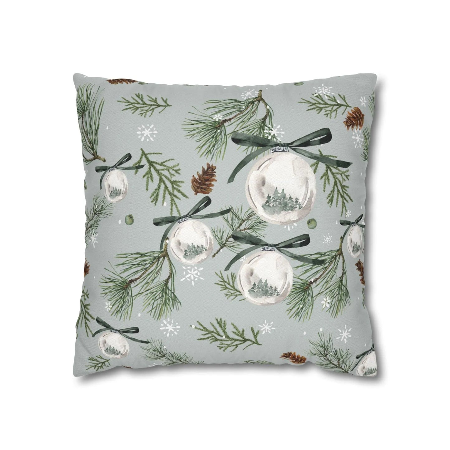 Watercolor pine Christmas ornament pillow with green branches and snowflakes on soft gray background