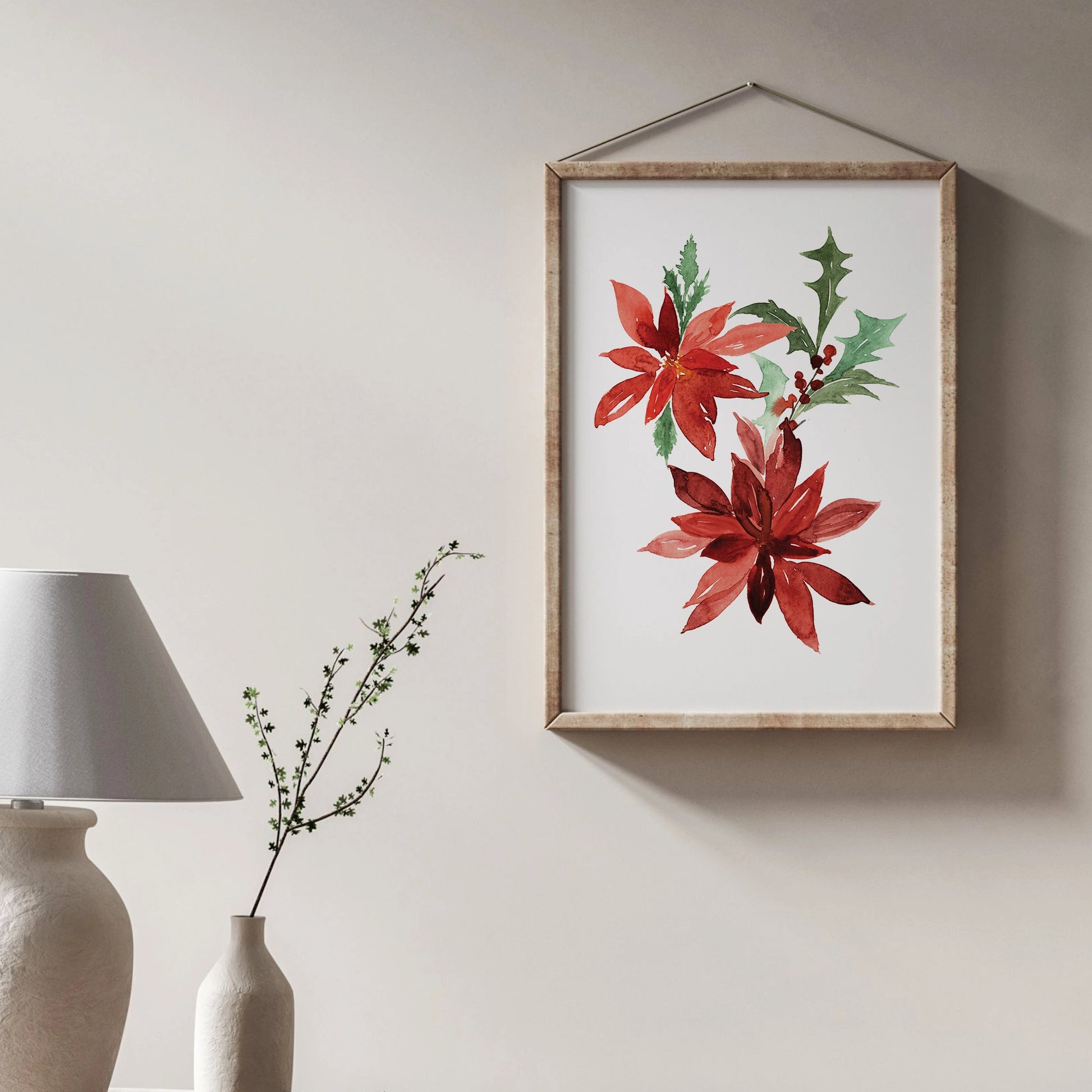 Poinsettia Christmas Art print displayed in a minimalistic room with a lamp and greenery.