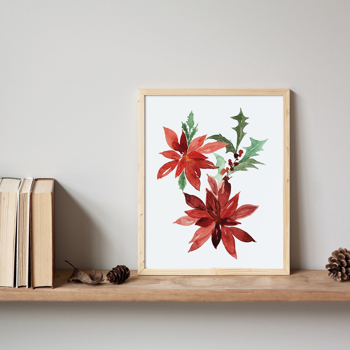 Poinsettia Christmas Art print featuring vibrant red flowers in a wooden frame on a shelf.