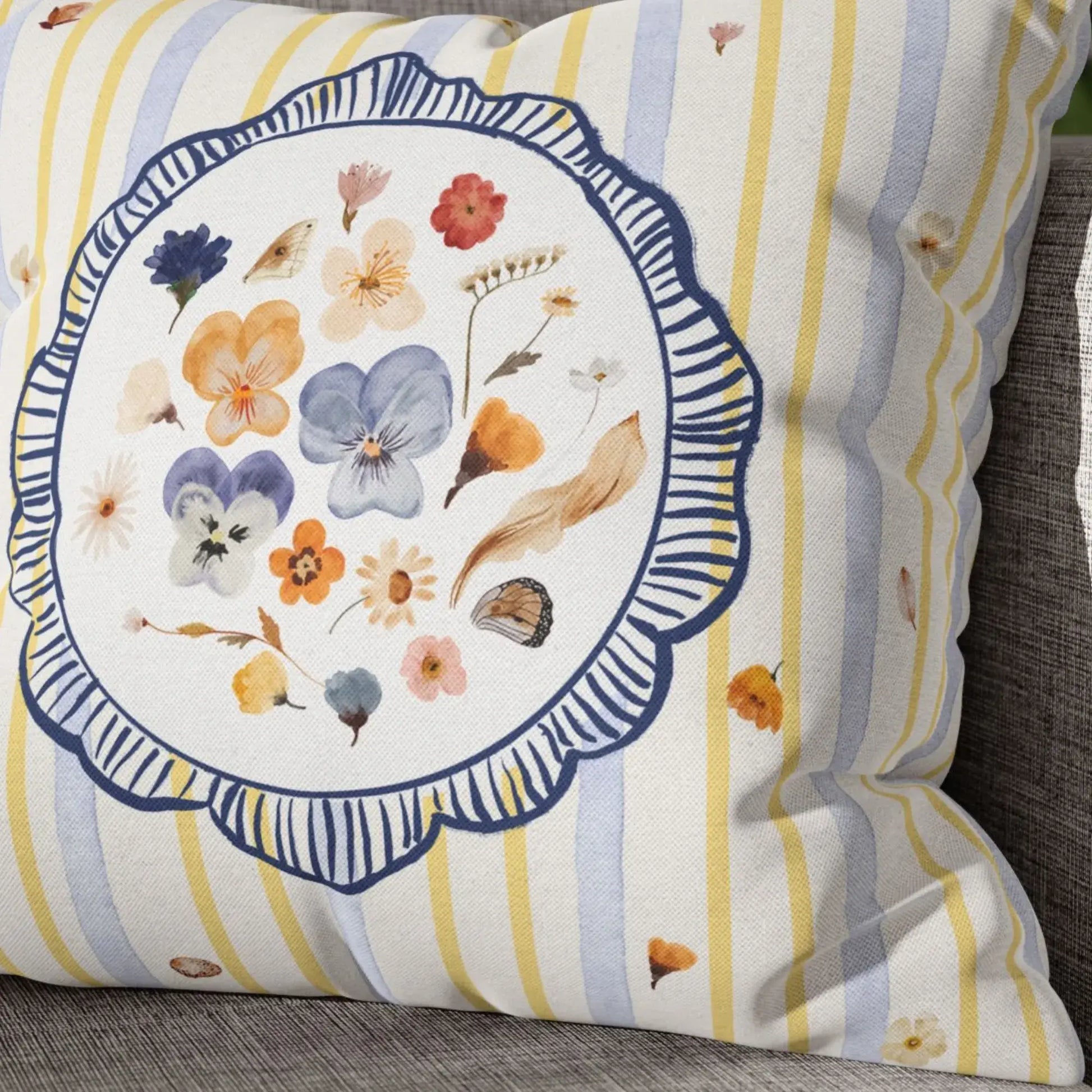 Watercolor Pressed Wildflower Pillow featuring soft florals and pastel tones on a striped background.