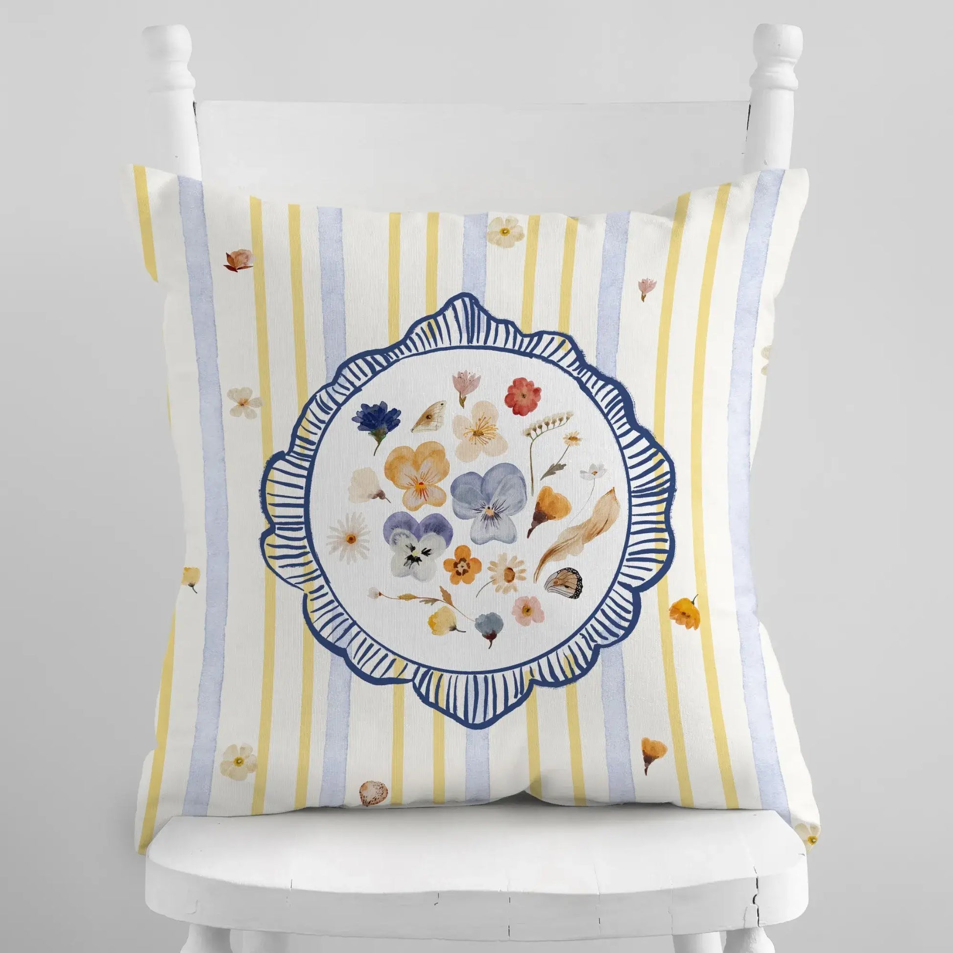 Watercolor Pressed Wildflower Pillow with floral design on a striped background, adding a fresh and bright touch to home decor.
