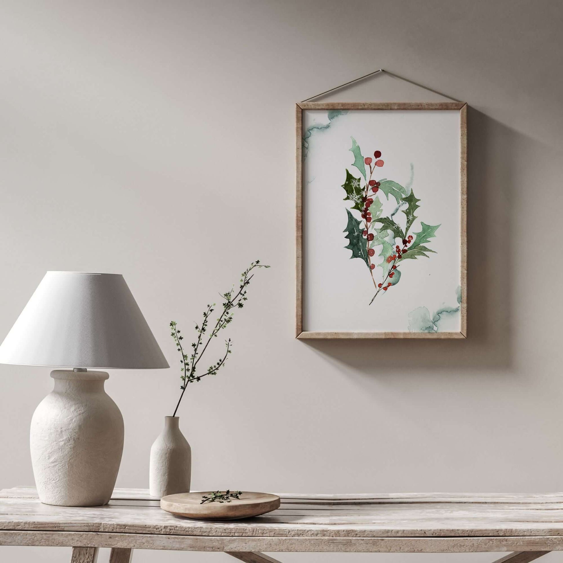 Watercolor Red Holly Berry Art Print from Blue Water Songs, elegantly framed in a natural wood frame hanging in white wall
