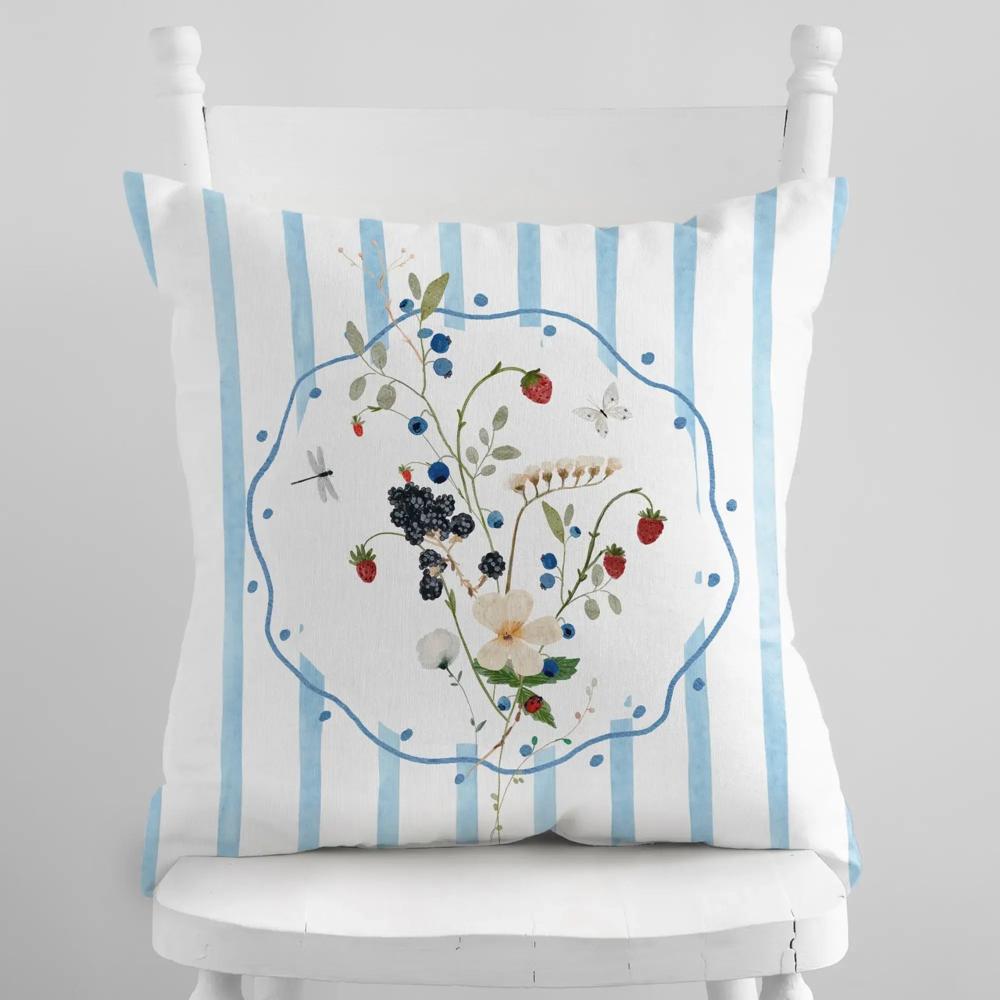 Watercolor Wildflower and Berry Pillow and Cover with delicate floral and berry design on blue striped background.