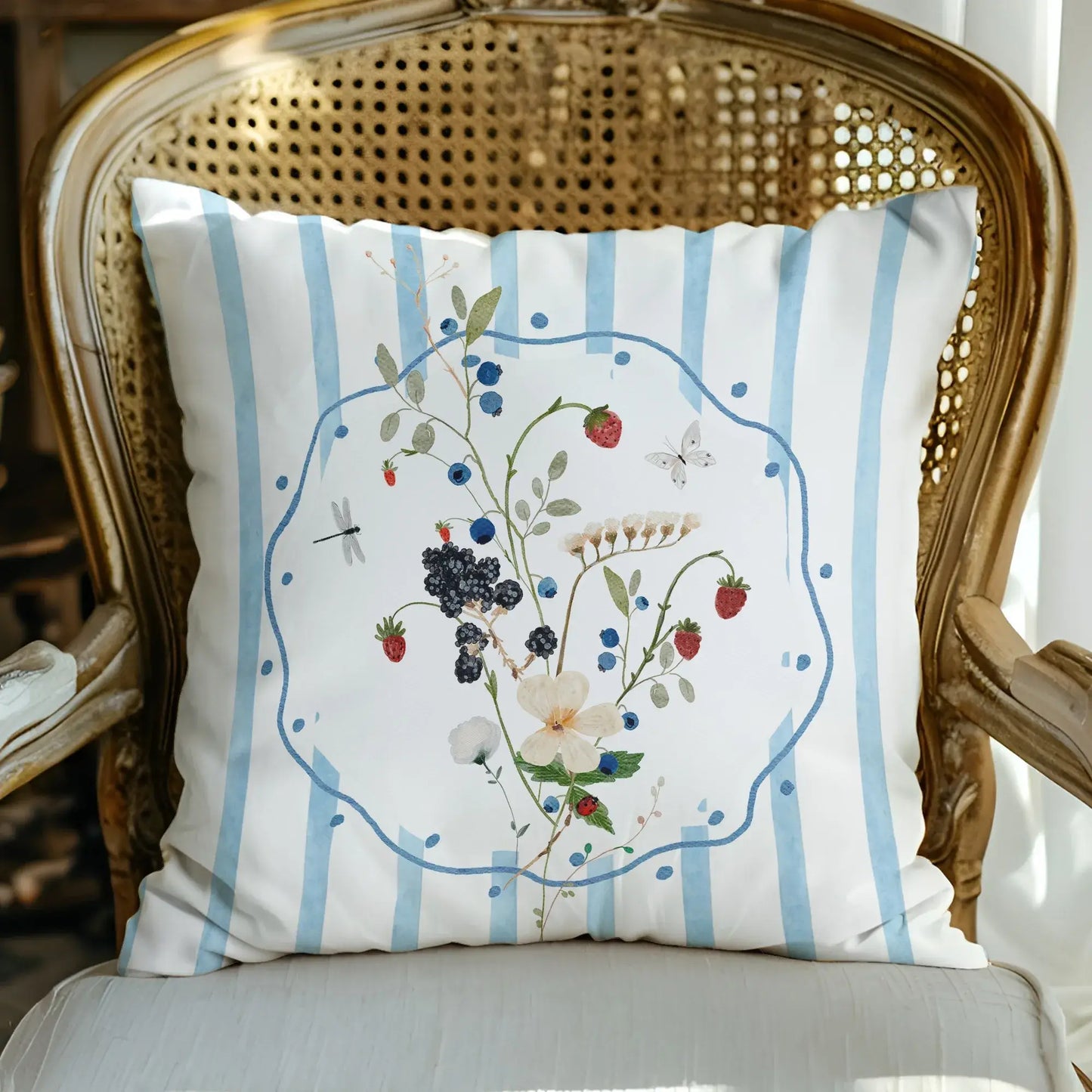 Watercolor Wildflower and Berry Pillow and Cover with delicate wildflowers and blue stripes on a cozy chair.