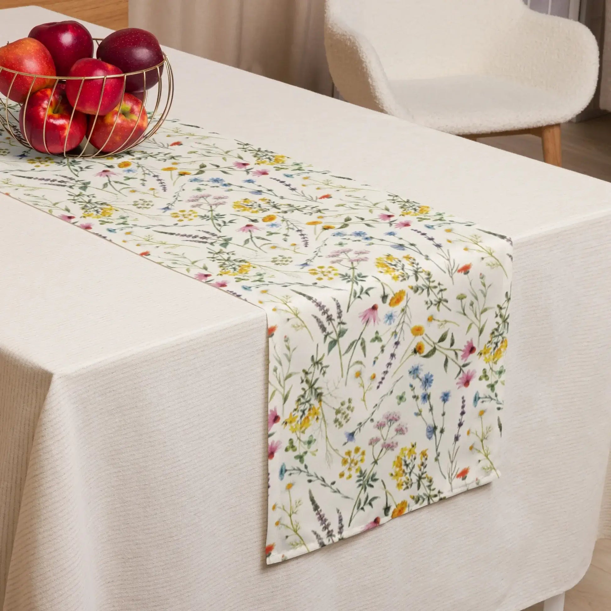 Watercolor Wildflowers Table Runner displayed on a dining table with a bowl of apples.