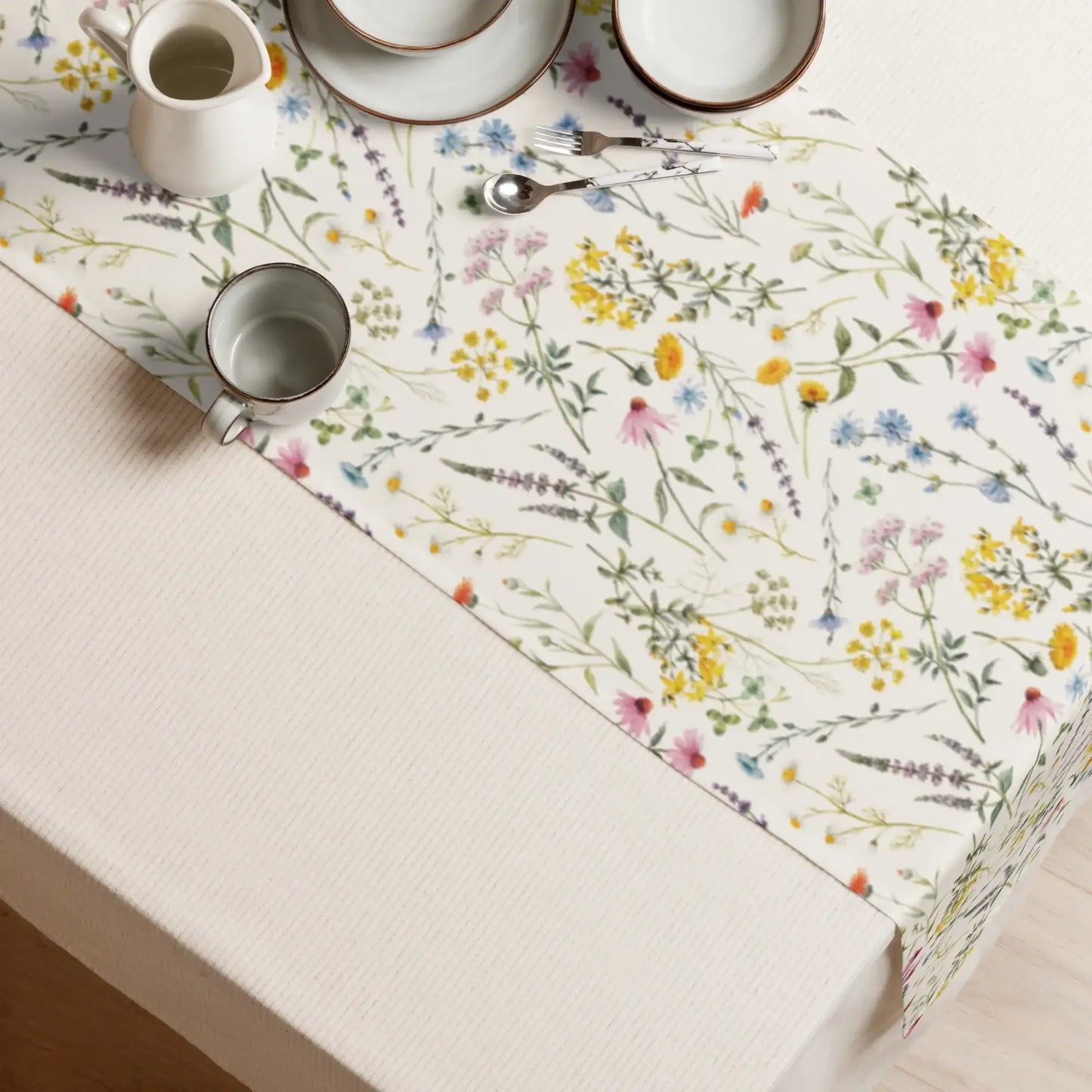 Watercolor Wildflowers Table Runner on a dining table with plates and utensils.