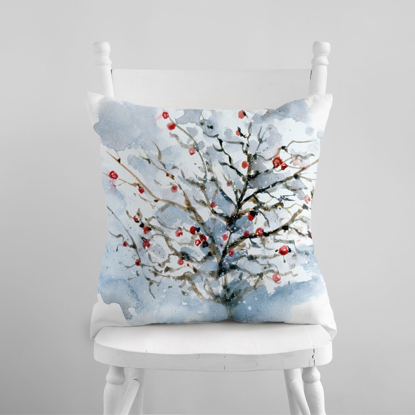 Watercolor winter tree pillow with red berries on snowy branches – nature-inspired Christmas decor