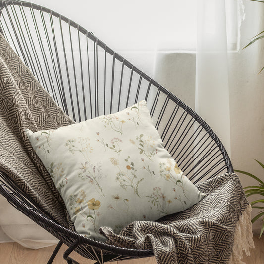 white wildflowers decorative pillow on relaxing chair