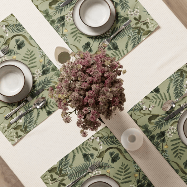 Wild Fern Garden Placemats styled on a dining table with dishes and a floral centerpiece.