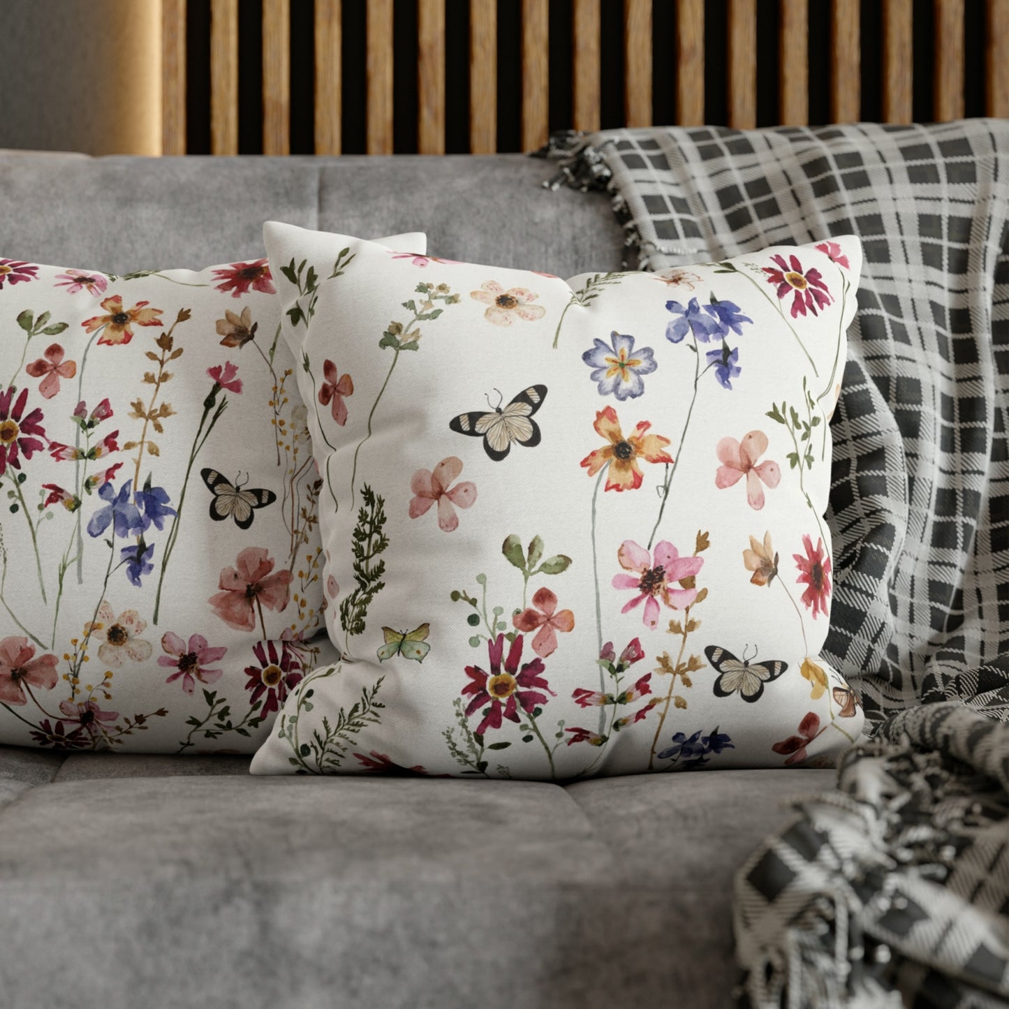 2 decorative pillows on grey couch 