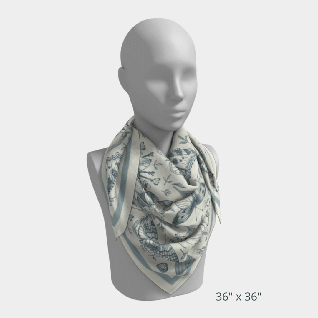 William Morris Silk Scarf Blue Moth displayed on a mannequin, showcasing delicate butterflies and floral designs.