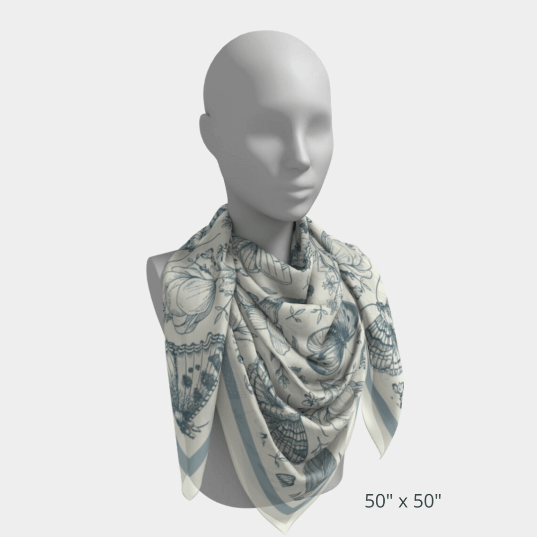 William Morris Silk Scarf Blue Moth size 50"x 50" displayed on a mannequin, featuring blue moths and floral designs.