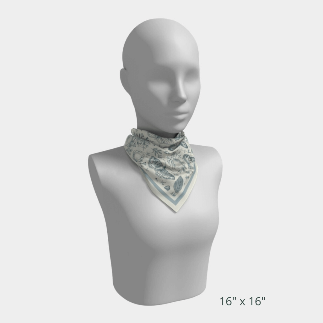 William Morris Silk Scarf Blue Moth displayed on mannequin, showcasing floral and butterfly designs in soft blue tones.