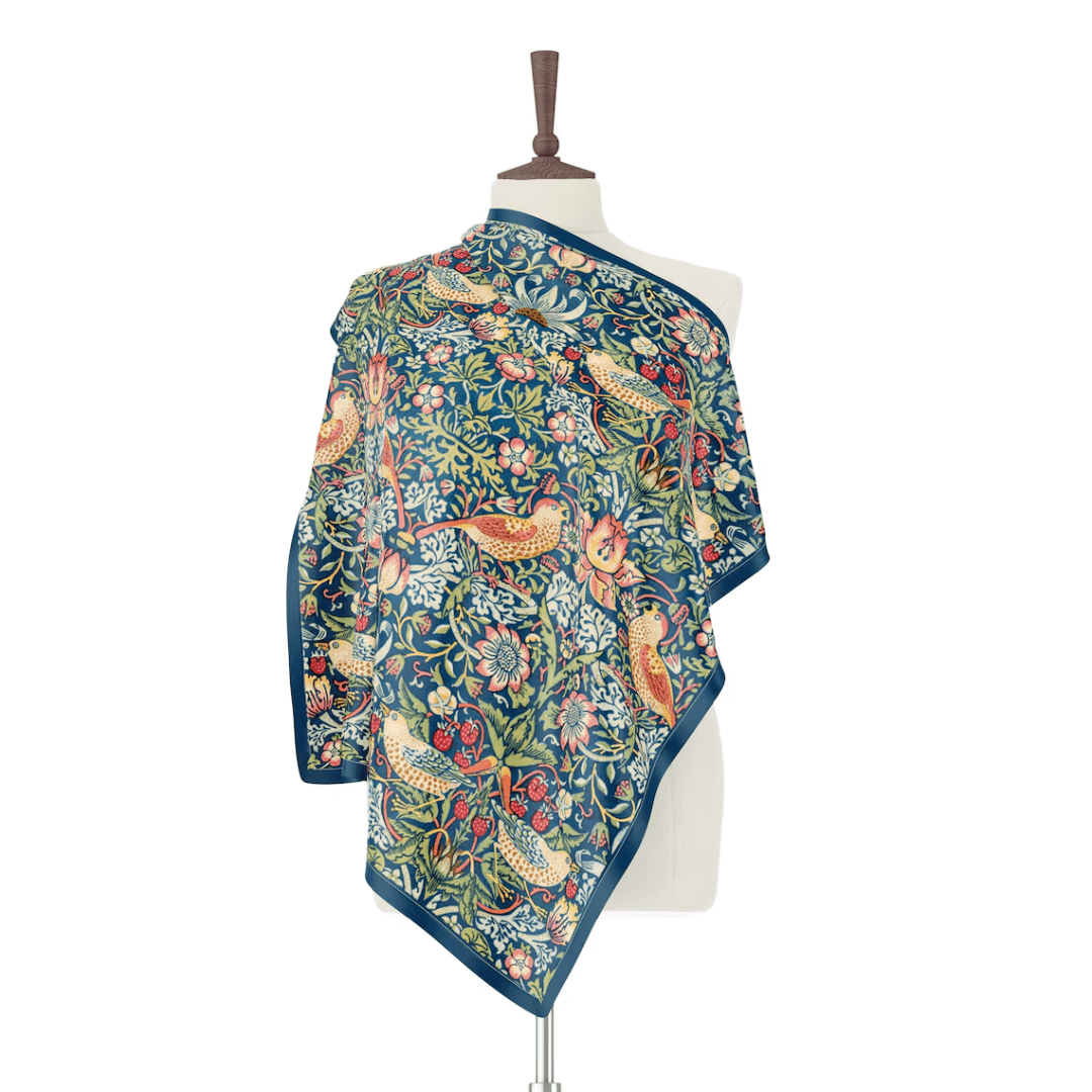William Morris Strawberry Thief silk scarf displayed on a mannequin showcasing William Morris iconic botanical and animal patterns