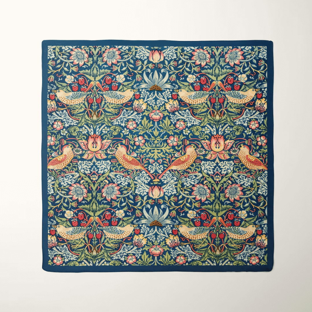 William Morris Strawberry Thief silk scarf featuring vibrant birds and floral patterns on a rich navy background.