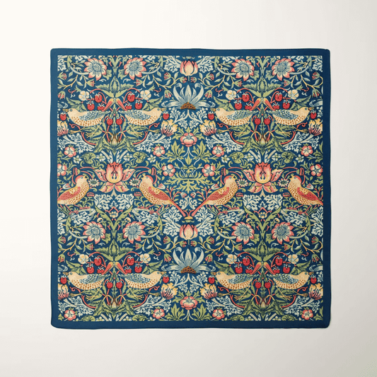 William Morris Strawberry Thief silk scarf featuring vibrant birds and floral patterns on a rich navy background.