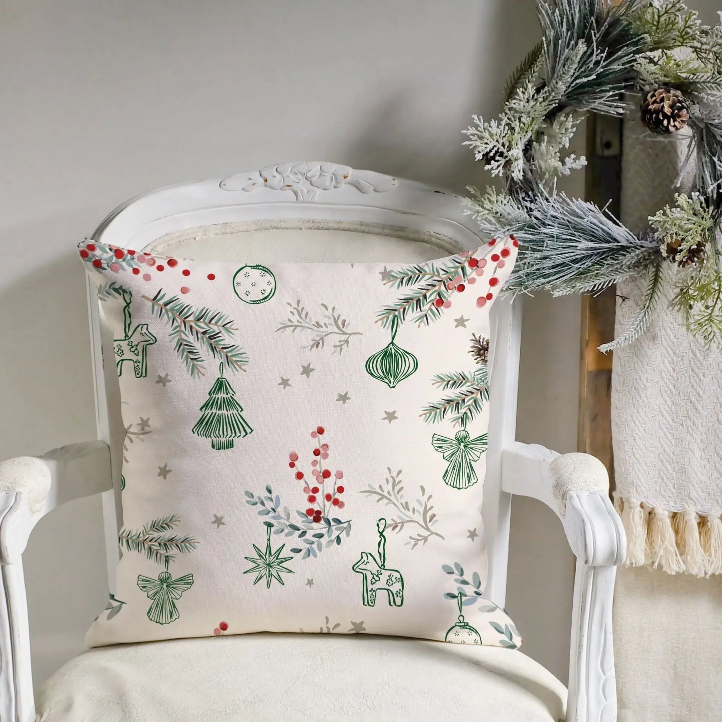 Winter berry Christmas pillow cover with green and red holiday designs on a cream background.