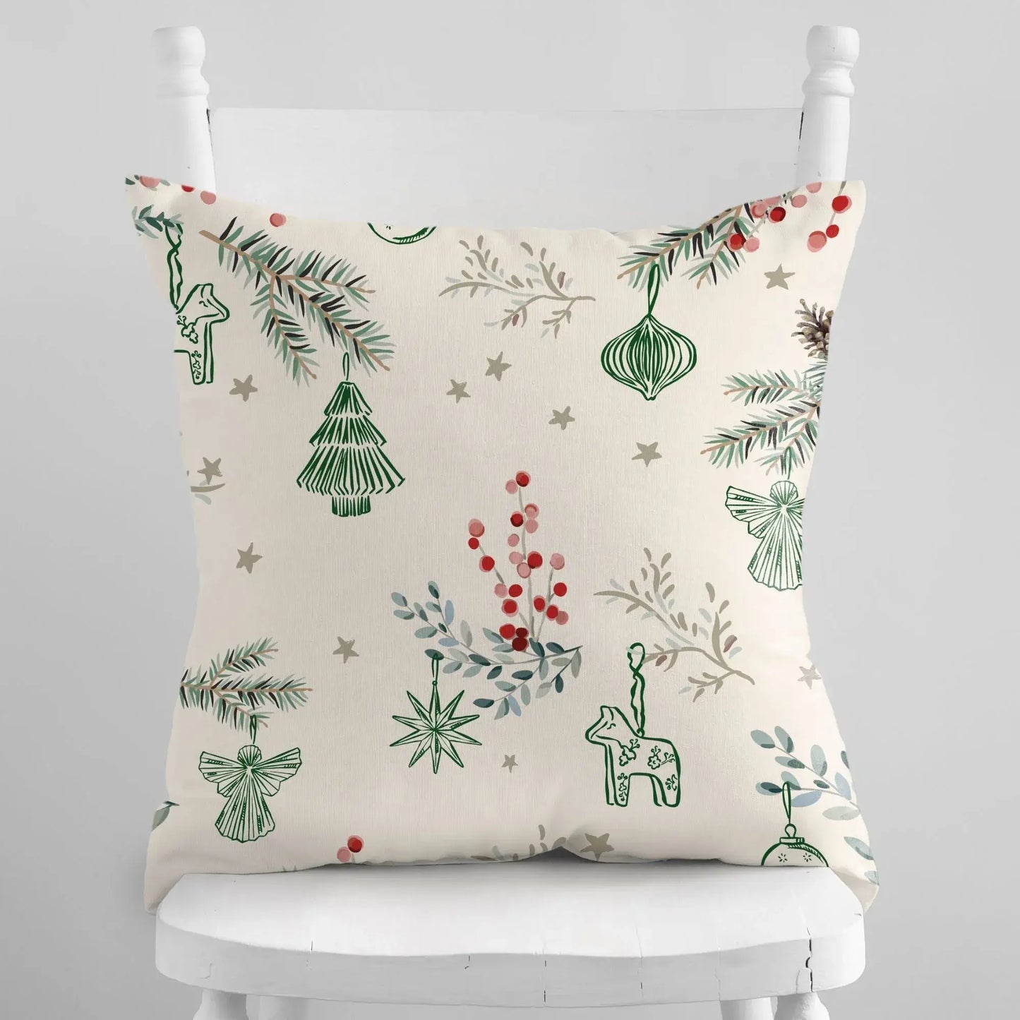 Winter berry Christmas pillow cover featuring festive patterns of berries, pine branches, and ornaments on a beige background.