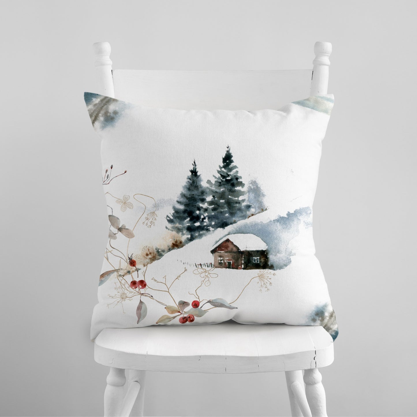 Watercolor winter landscape pillow with snowy cabin and pine trees – cozy seasonal decor