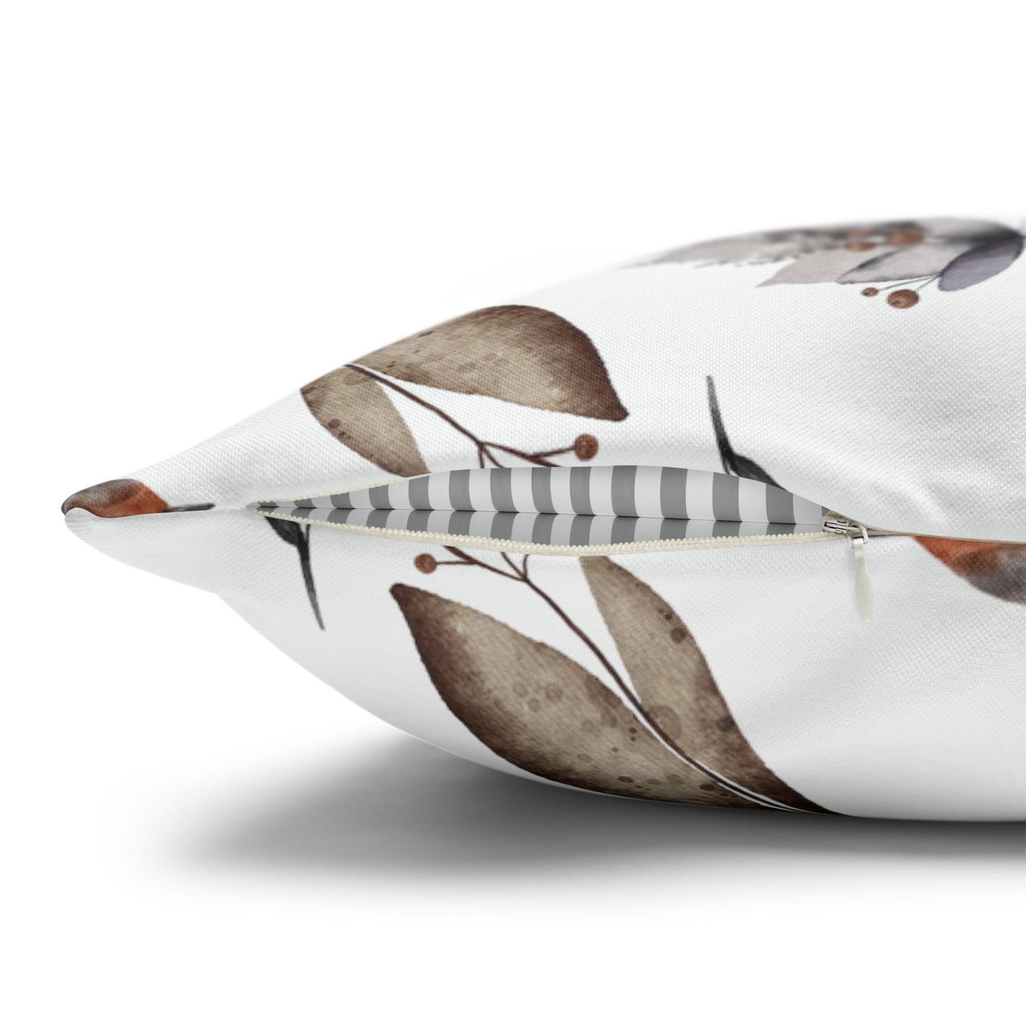 Close-up of winter botanical pillow with brown watercolor leaves and hidden zipper detail